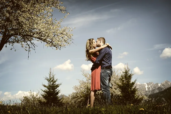 Framed Print : Lovers kissing next to a flowering tree in the spring
