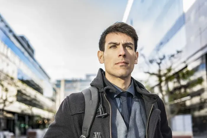 Framed Print : Low-angle view of an attractive businessman with his backpack on looking away while walking from his office