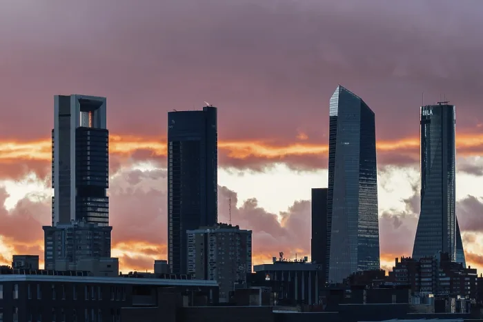 Framed Print : Madrid, Spain - December 8, 2024: Cuatro Torres Business Area set against a stunning Framed Print : Madrid, Spain - December 8, 2024: Cuatro Torres Business Area set against a stunning