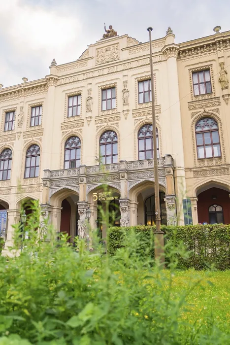 Framed Print : A magnificent historic building with ornate facades surrounded by lush green plants
