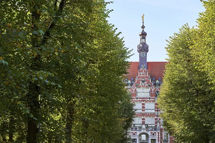 Framed Print : The main building of Gdansk University of Technology or Politechnika Gdanska among trees on the approaching alley