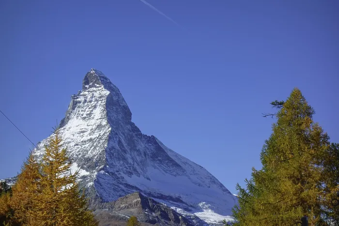 Framed Print : Majestic Matterhorn with snowy summit surrounded by autumn trees Framed Print : Majestic Matterhorn with snowy summit surrounded by autumn trees