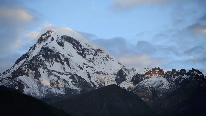 Framed Print : Majestic snow-covered mountain under cloudy sky
