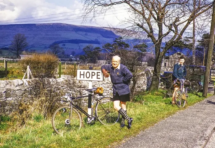 Framed Print : Two male cyclists at the town sign of Hope, Peak District National Park, Derbyshire, England, UK 1956