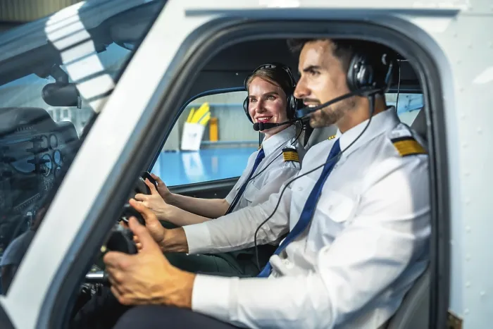 Framed Print : Male and female pilots, wearing headsets and smiling