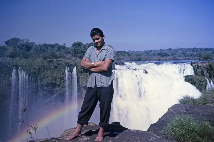 Framed Print : Male tour guide standing barefoot at the edge of the Iguazu Falls on the Iguazu River, on the border between Brazil and Argentina, South America, 1962