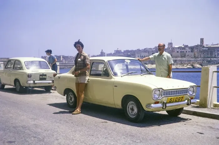 Framed Print : Male tourists standing by Avis hire car, Ford Escort Mk 1, Valletta, Malta, Europe 1971, Europe