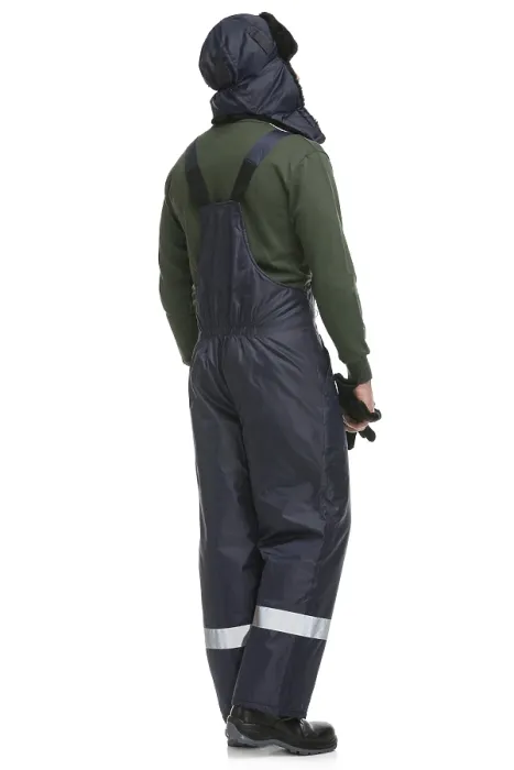 Framed Print : Man in blue work overalls and winter cap isolated full-length rearview