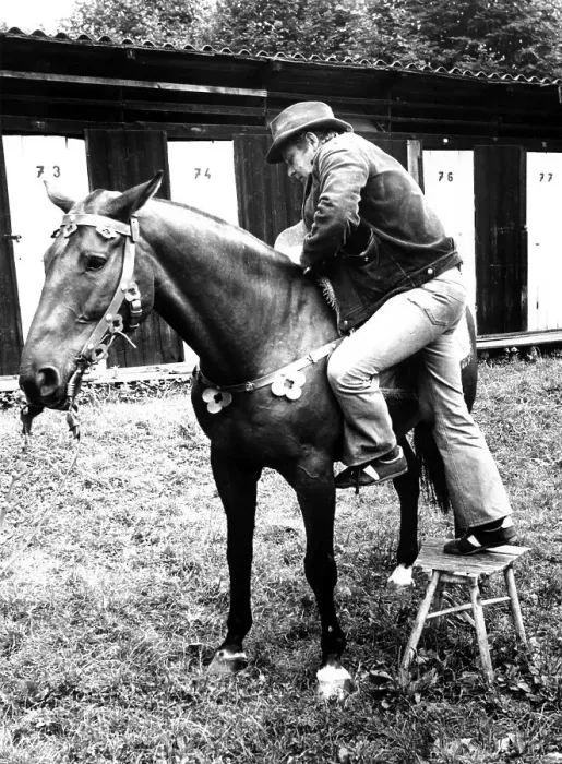Framed Print : Man climbs with stool on horse ca