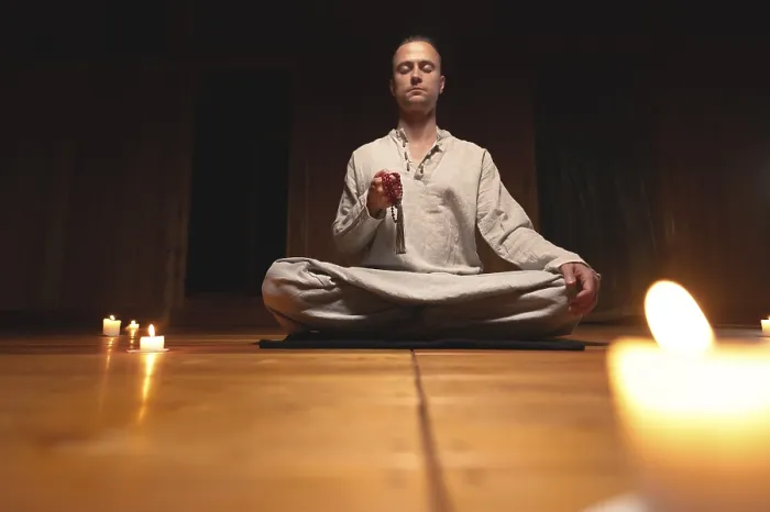 Framed Print : A man in clothes for practice and meditation sits in a lotus pose