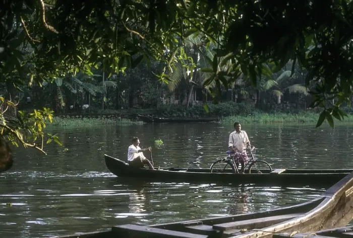 Framed Print : A man crossing the backwater with bicycle Framed Print : A man crossing the backwater with bicycle