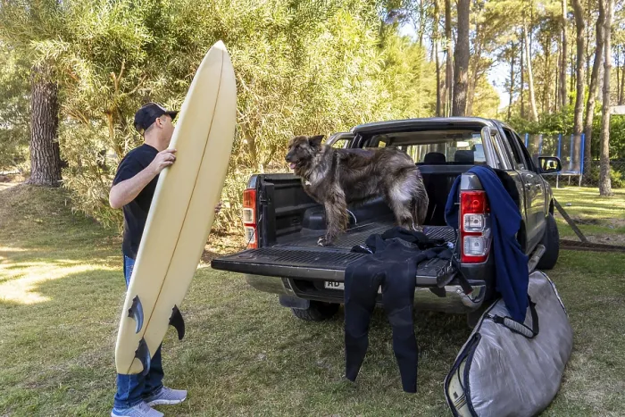 Framed Print : Man and his dog getting ready for a surf trip