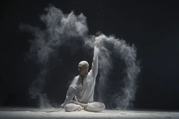 Framed Print : Man doing yoga in white dust cloud in dark room full-length shot