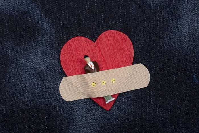 Framed Print : Man figurine on heart icon, Love and Valentines day concept