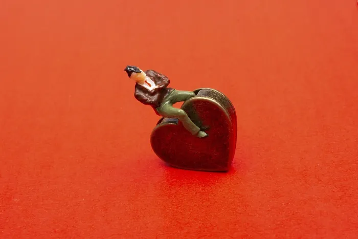 Framed Print : Man figurine on a Heart shape as love conception