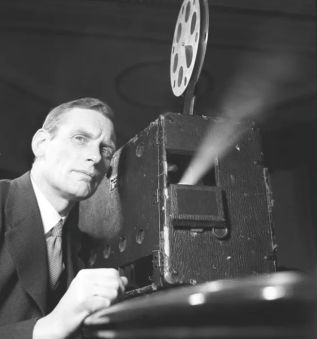 Framed Print : Man at a film projector in the 1940s Framed Print : Man at a film projector in the 1940s