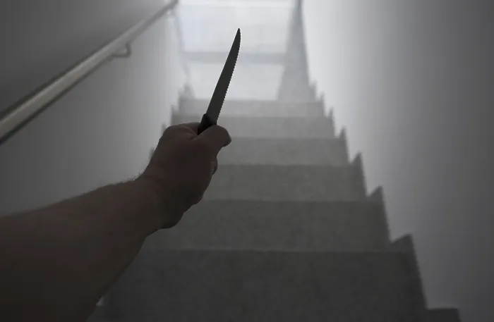 Framed Print : Man Holding a Knife in the Staircase with a Window Light in Switzerland