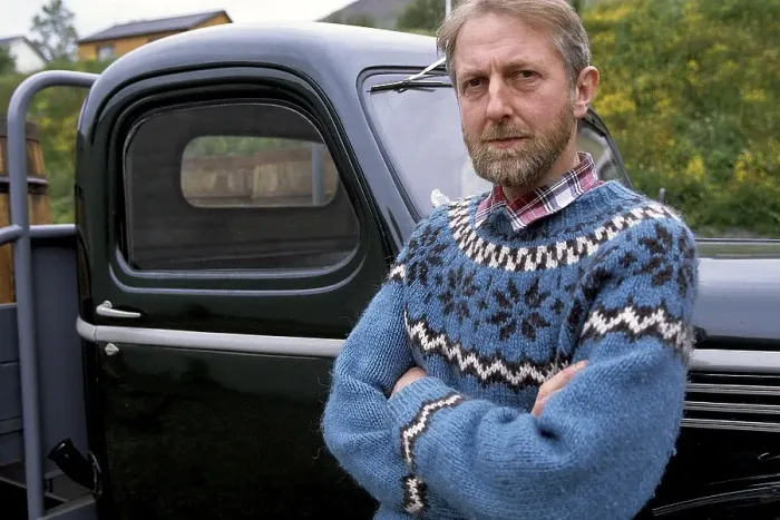 Framed Print : Man in Icelandic sweater in front of oldtimer