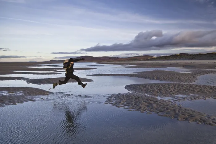 Framed Print : Man jumping over tidal sea puddles Framed Print : Man jumping over tidal sea puddles