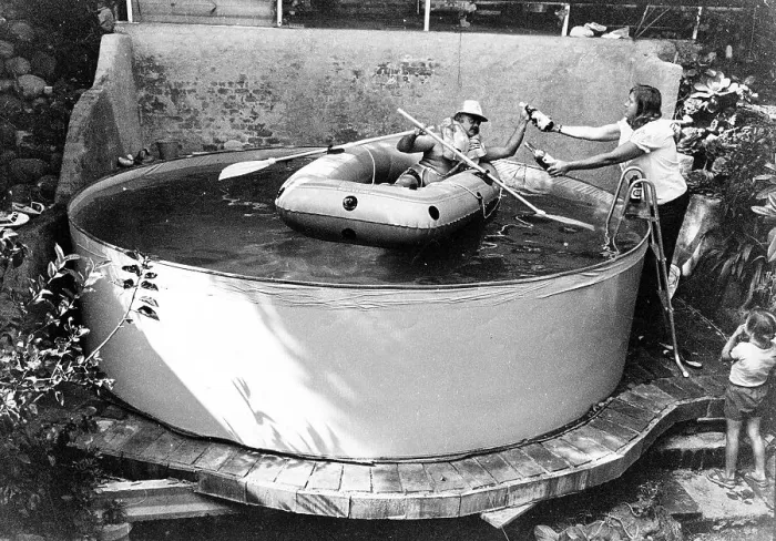 Framed Print : Man with lifejacket in inflatable dinghy in paddling pool