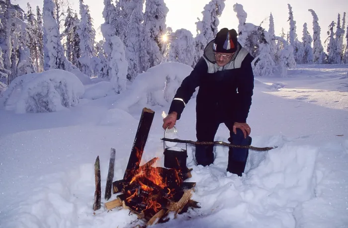 Framed Print : Man lighting campfire in taiga, Finland, Europe Framed Print : Man lighting campfire in taiga, Finland, Europe
