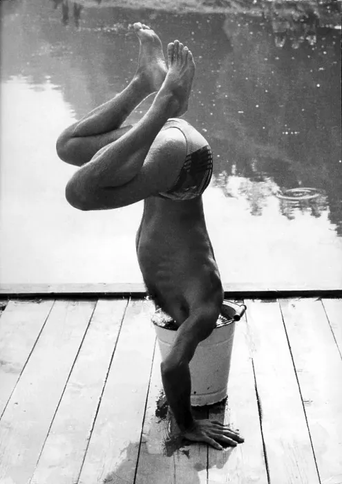 Framed Print : Man makes handstand and sticks head in bucket ca
