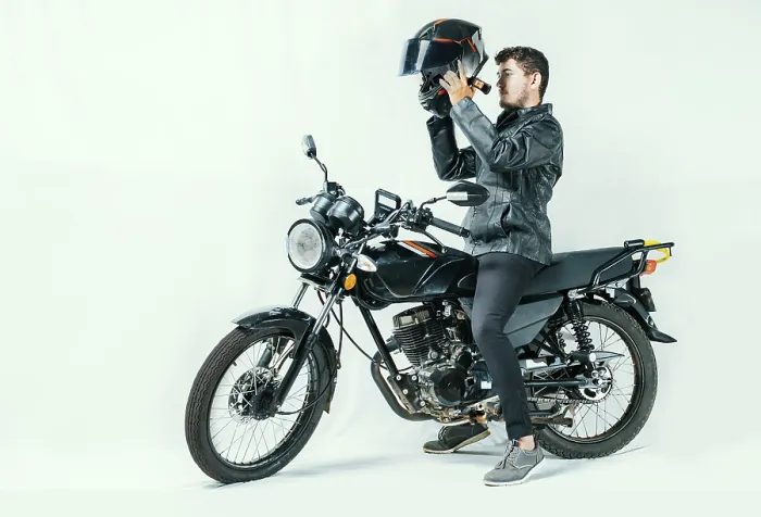 Framed Print : Man on motorcycle putting on helmet Framed Print : Man on motorcycle putting on helmet