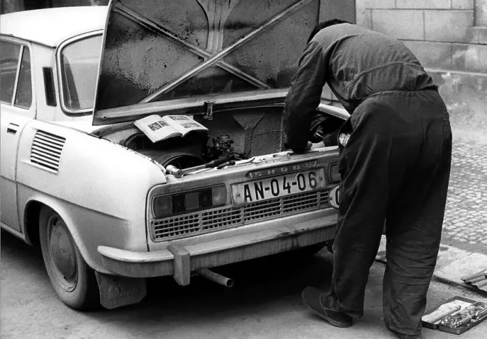 Framed Print : Man repairing car after instruction ca Framed Print : Man repairing car after instruction ca