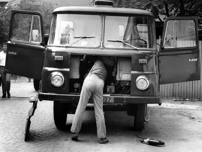Framed Print : Man repairing trucks ca. 1970s