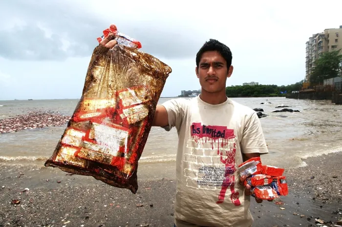 Framed Print : Man showing oil soaked biscuit packets due to container ship chitra colliding in sea Bombay Mumbai