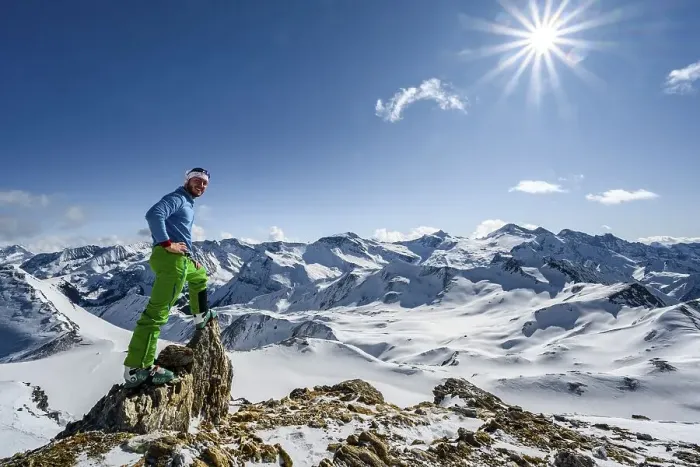 Framed Print : Man, ski tourer looks over snow-covered mountain ranges