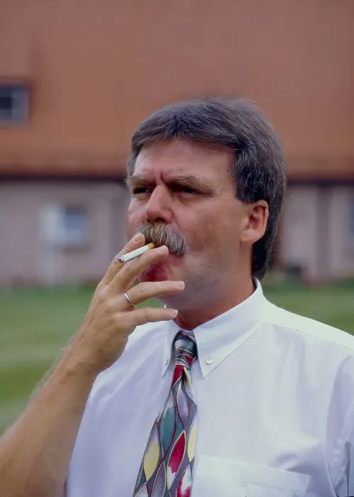 Framed Print : Man smokes cigarette outdoors