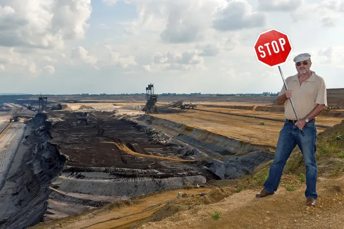 Framed Print : Man standing on the edge of an open pit