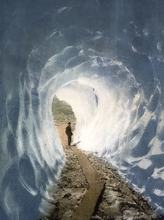Framed Print : A man standing at the entrance to an ice cave at the Grindelwald Grotto Framed Print : A man standing at the entrance to an ice cave at the Grindelwald Grotto