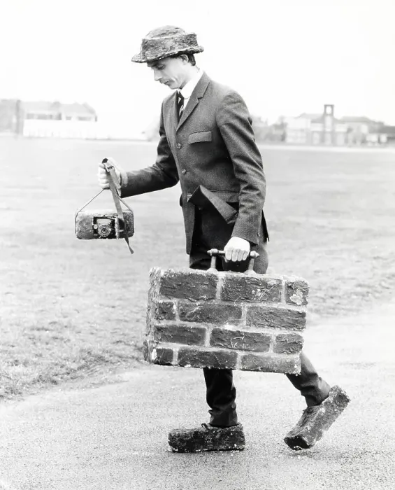 Framed Print : Man with suitcase, shoes and camera made of bricks Framed Print : Man with suitcase, shoes and camera made of bricks