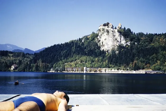 Framed Print : Man sunbathing by lakeside with view to castle, Bled, Slovenia, former Yugoslavia, Europe 1960, Europe