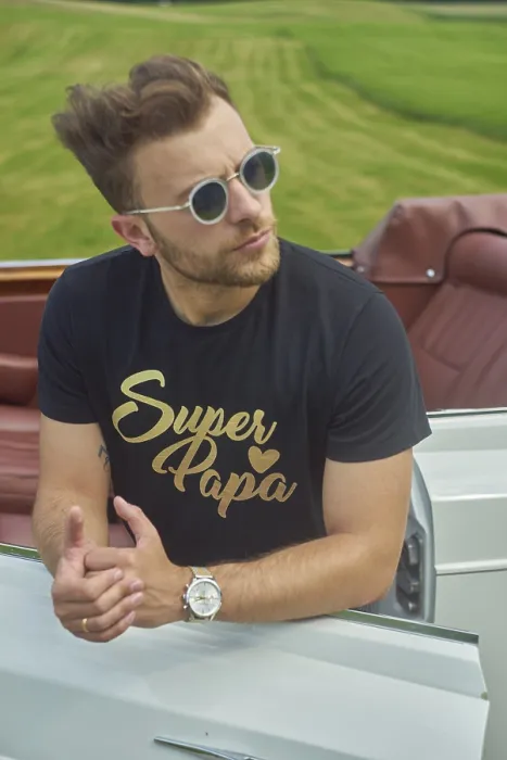 Framed Print : Man in sunglasses leaning casually on a convertible set against a scenic green field Framed Print : Man in sunglasses leaning casually on a convertible set against a scenic green field
