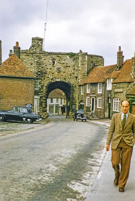 Framed Print : Man walking on the pavement with the Landgate gatehouse, Rye, East Sussex, England, UK 1956