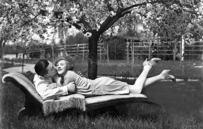 Framed Print : Man and woman lying outdoors on a sofa Framed Print : Man and woman lying outdoors on a sofa
