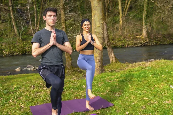 Framed Print : Man and woman practicing yoga tree pose by a river in a forest Framed Print : Man and woman practicing yoga tree pose by a river in a forest