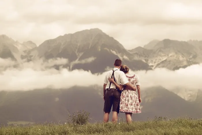 Framed Print : Man and a woman wearing traditional costume looking towards the mountains