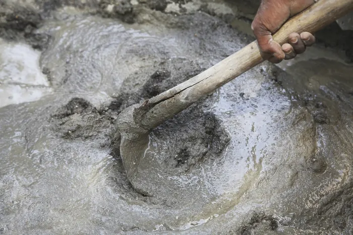 Framed Print : Manually mixing cement sand and water for plaster with help of spade hoe
