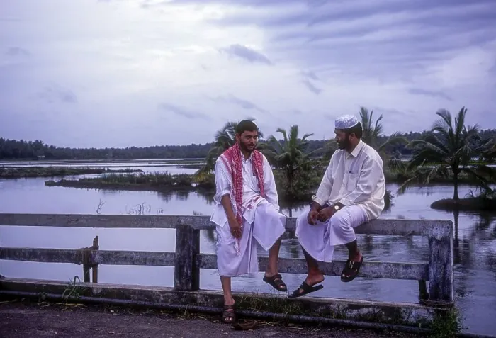 Framed Print : Mappila Muslims sitting on bridge handrail wall in Kodungallur
