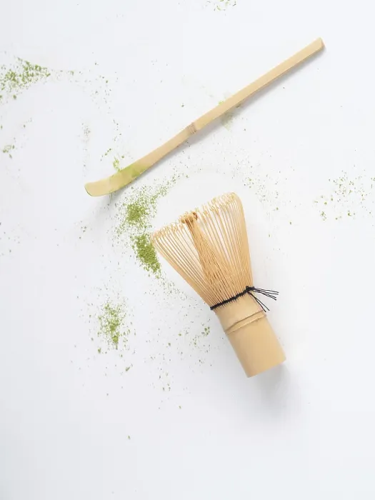 Framed Print : Matcha tea ceremony tools with scattered green powder on white background