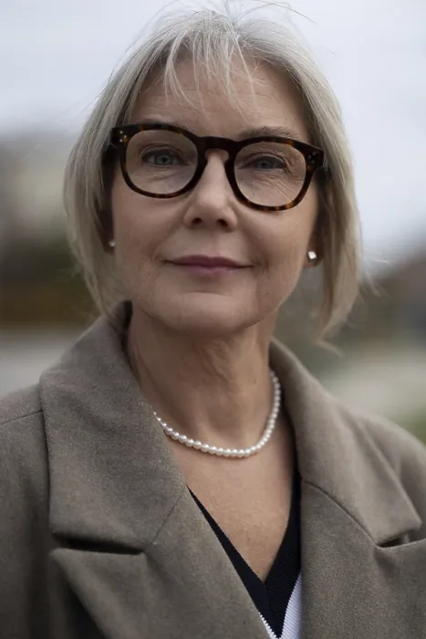 Framed Print : A mature businesswoman stands outside