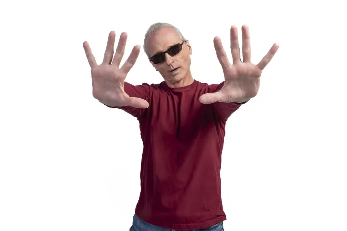 Framed Print : Mature man wearing sunglasses showing stop gesture with both hands Framed Print : Mature man wearing sunglasses showing stop gesture with both hands