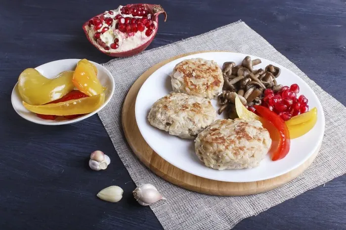Framed Print : Meatballs with rice mushrooms, sweet peppers and pomegranate seeds on black wooden background