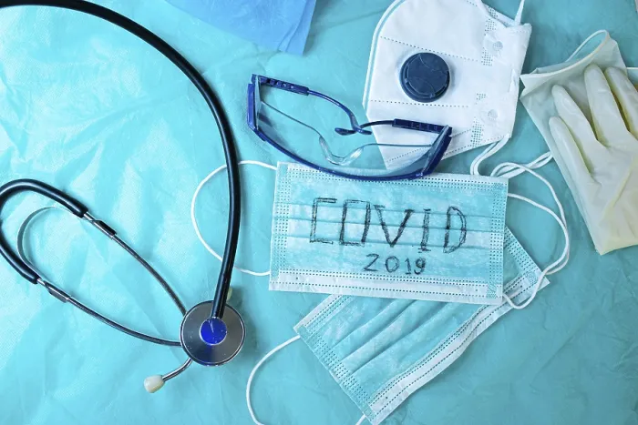Framed Print : Medical equipment including stethoscope and mask on blue backdrop