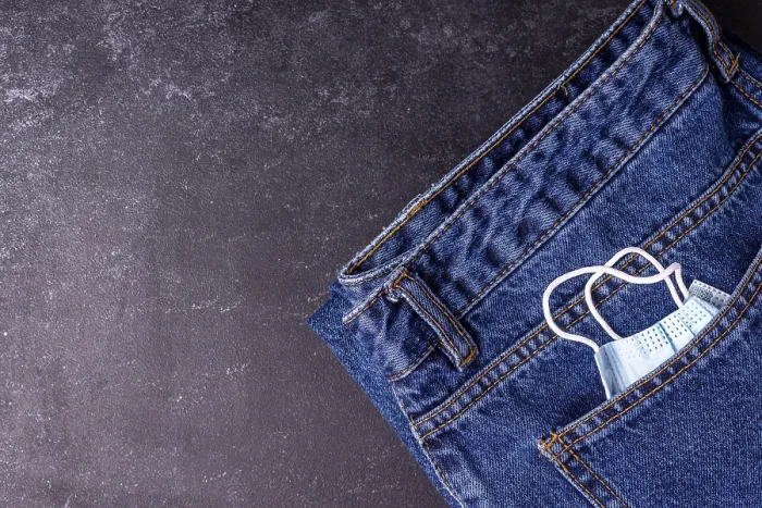 Framed Print : A medical mask peeks out of a jeans pocket