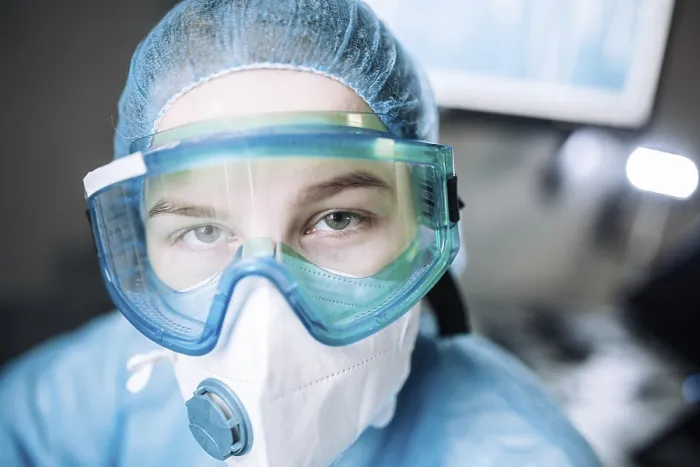 Framed Print : Medical professional wearing full protective gear including mask and goggles